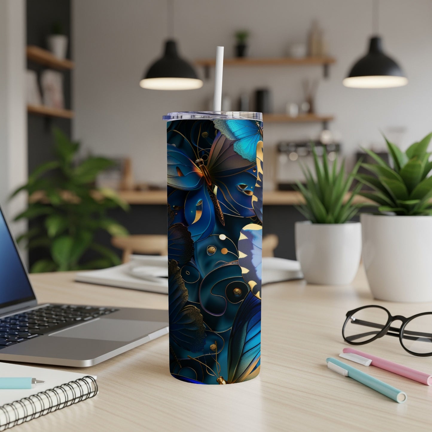 Blue butterfly design on a tall tumbler with a straw.