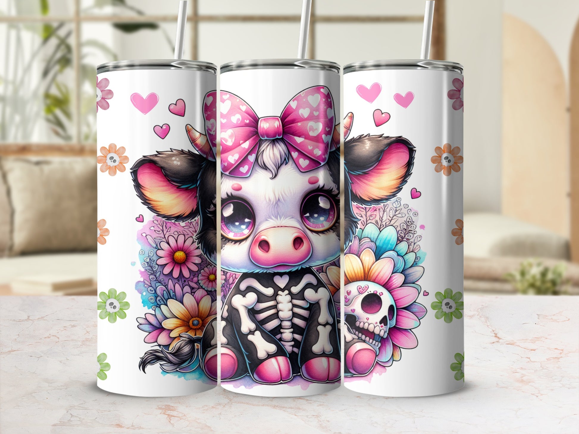 Three tumblers featuring a cartoon cow wearing a skeleton outfit and a pink bow.