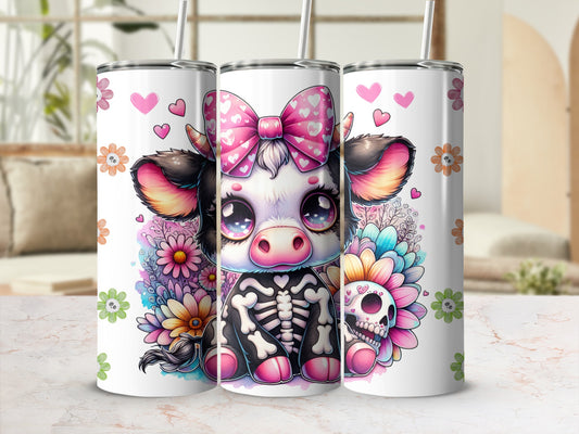 Three tumblers featuring a cartoon cow wearing a skeleton outfit and a pink bow.