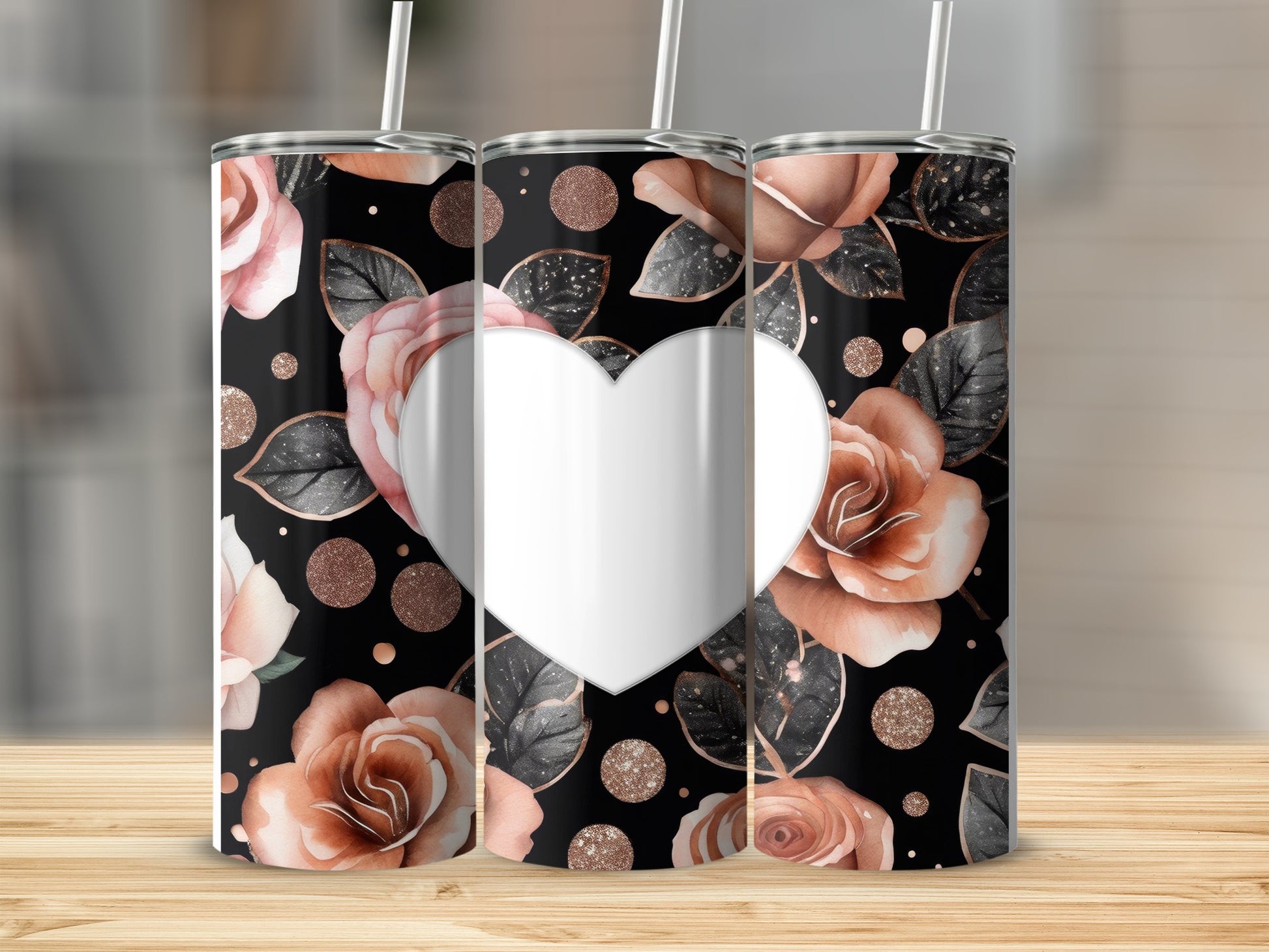 Three tumblers with rose and heart pattern on a wooden surface.