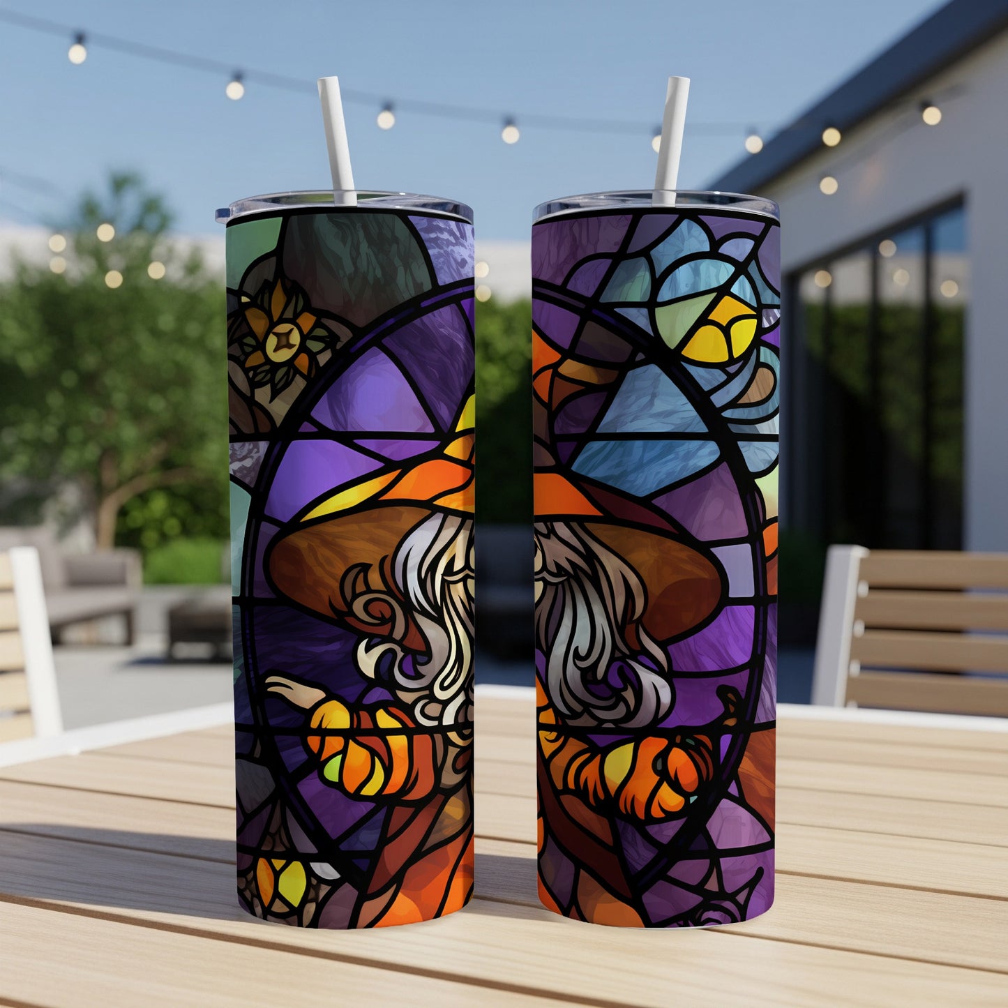 Two stained-glass tumblers featuring a witch with pumpkins and floral accents.