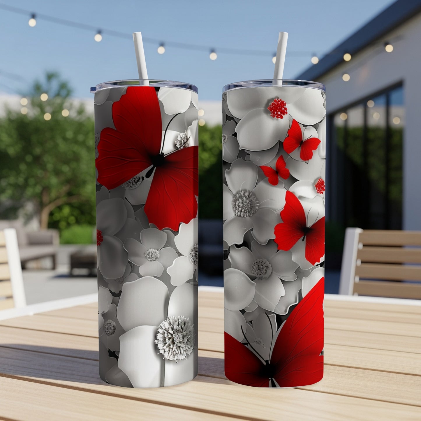 Two tumblers with red butterflies and white flowers.