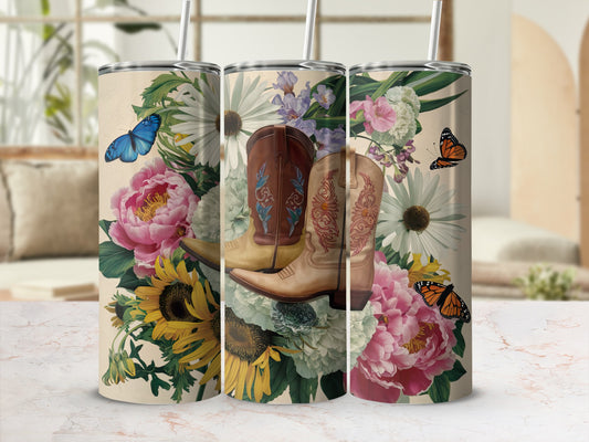 Tan tumbler with cowboy boots and floral design, featuring butterflies.