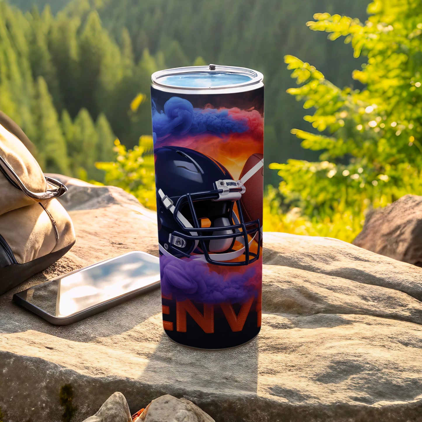 Black football helmet and ball with purple and orange smoke on tumbler.