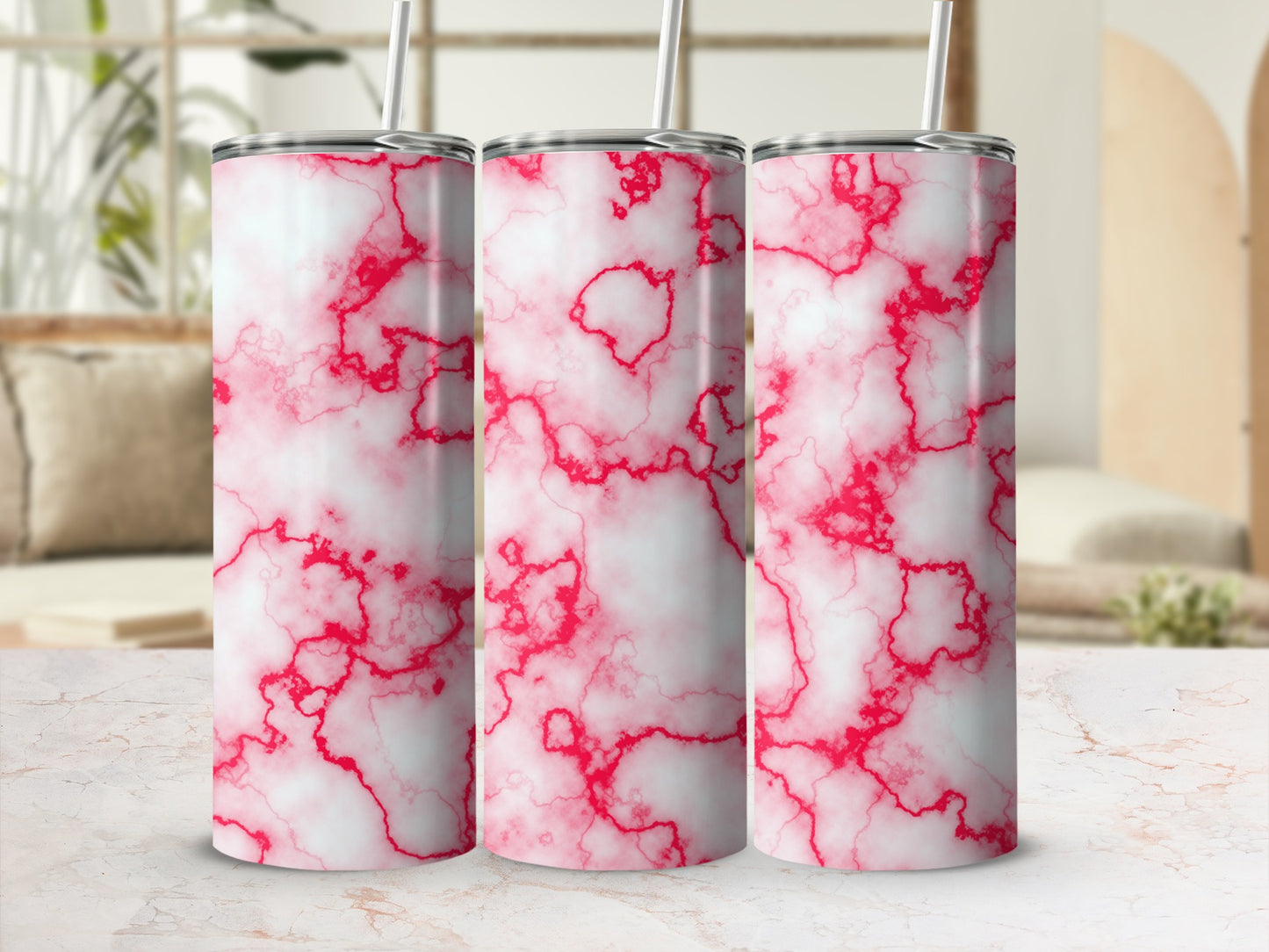 Three tumblers with red and white marble patterns stand on a surface.