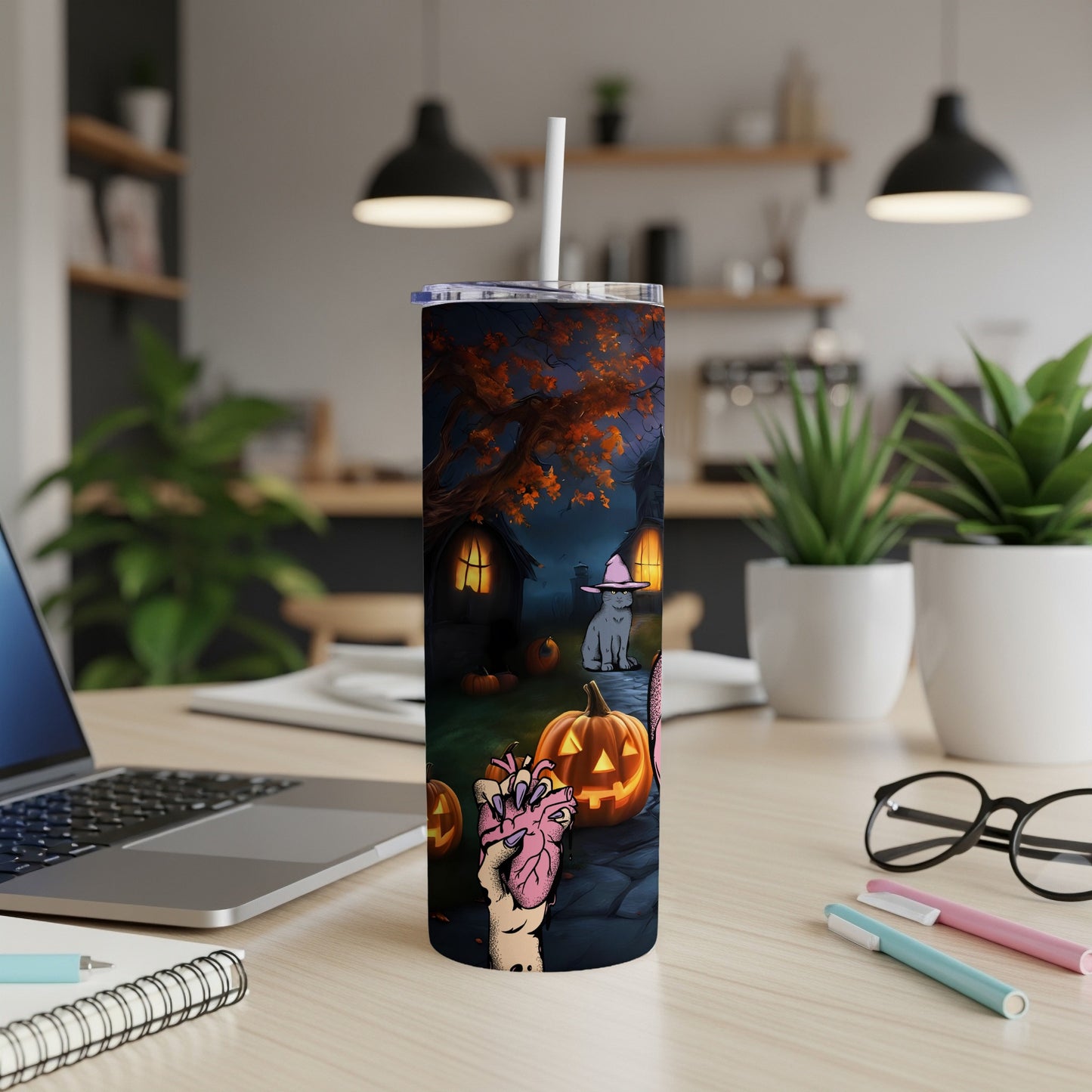 Halloween tumbler with spooky haunted house, pumpkins, a cat, and a creepy hand holding a heart.