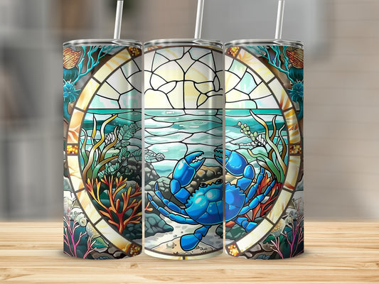 Stained glass tumbler with blue crab and underwater scene.
