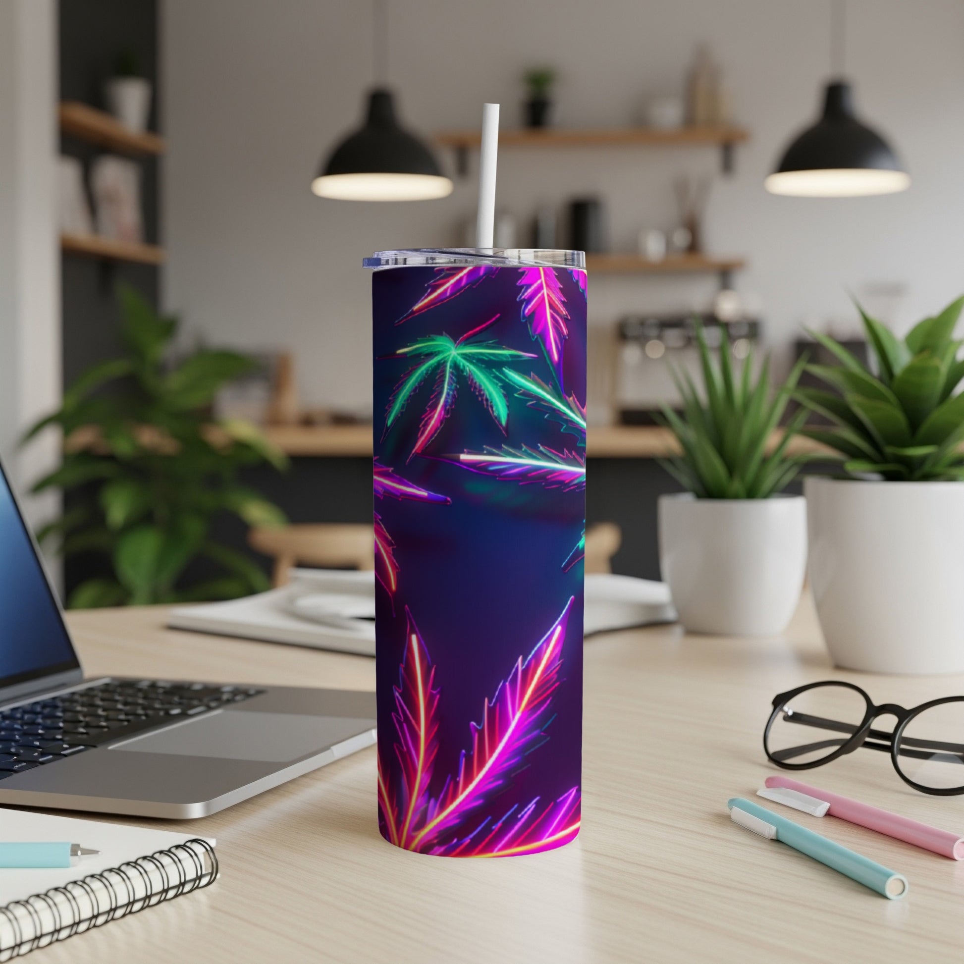 Purple tumbler with neon cannabis leaf design and white straw.