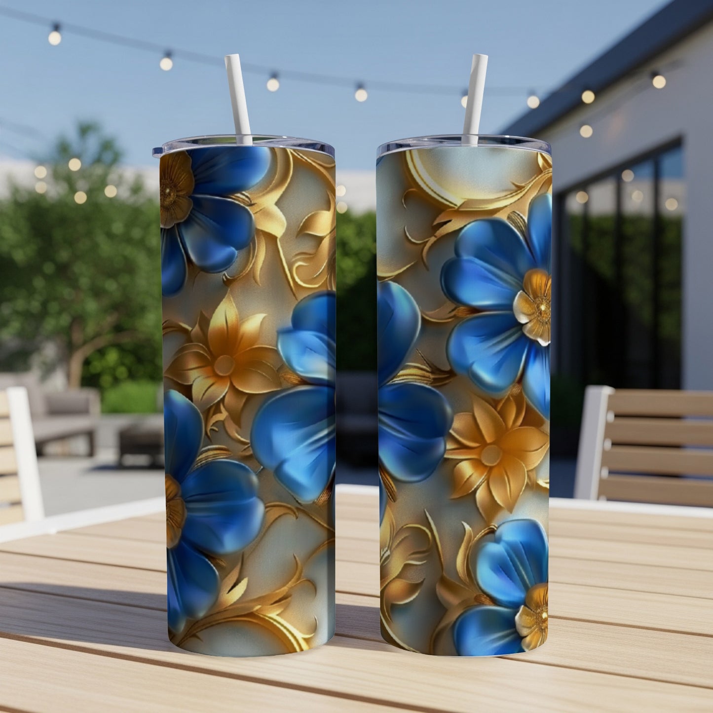 Two tumblers with blue flowers and gold accents on a wooden table.