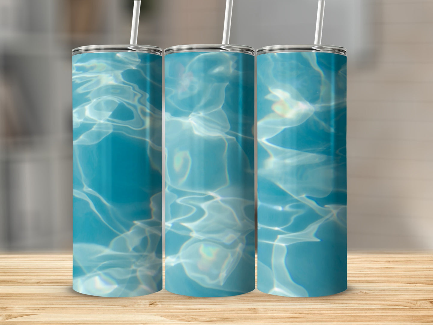 Three tumblers with shimmering water surface pattern.