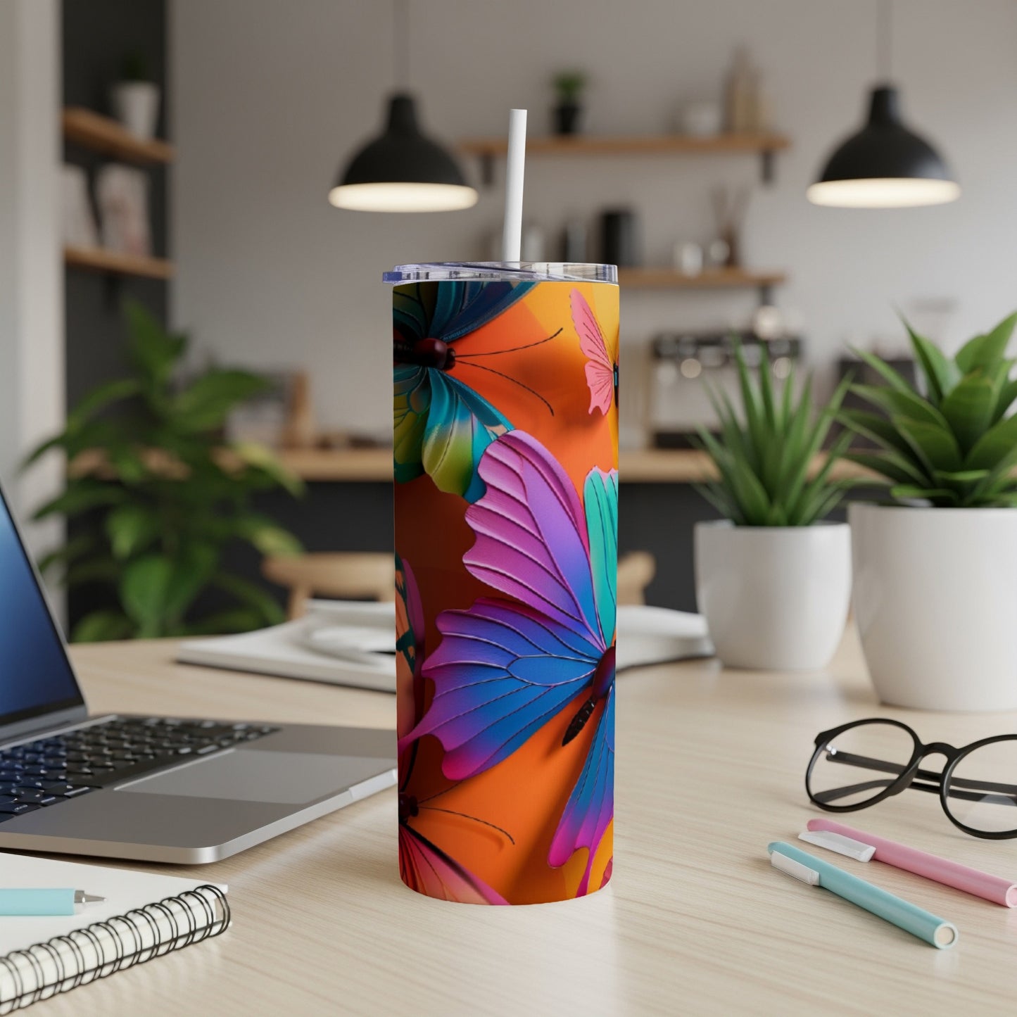 Tall tumbler with colorful butterfly design on an orange background.