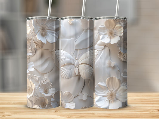 Three white tumblers with embossed floral and butterfly designs.