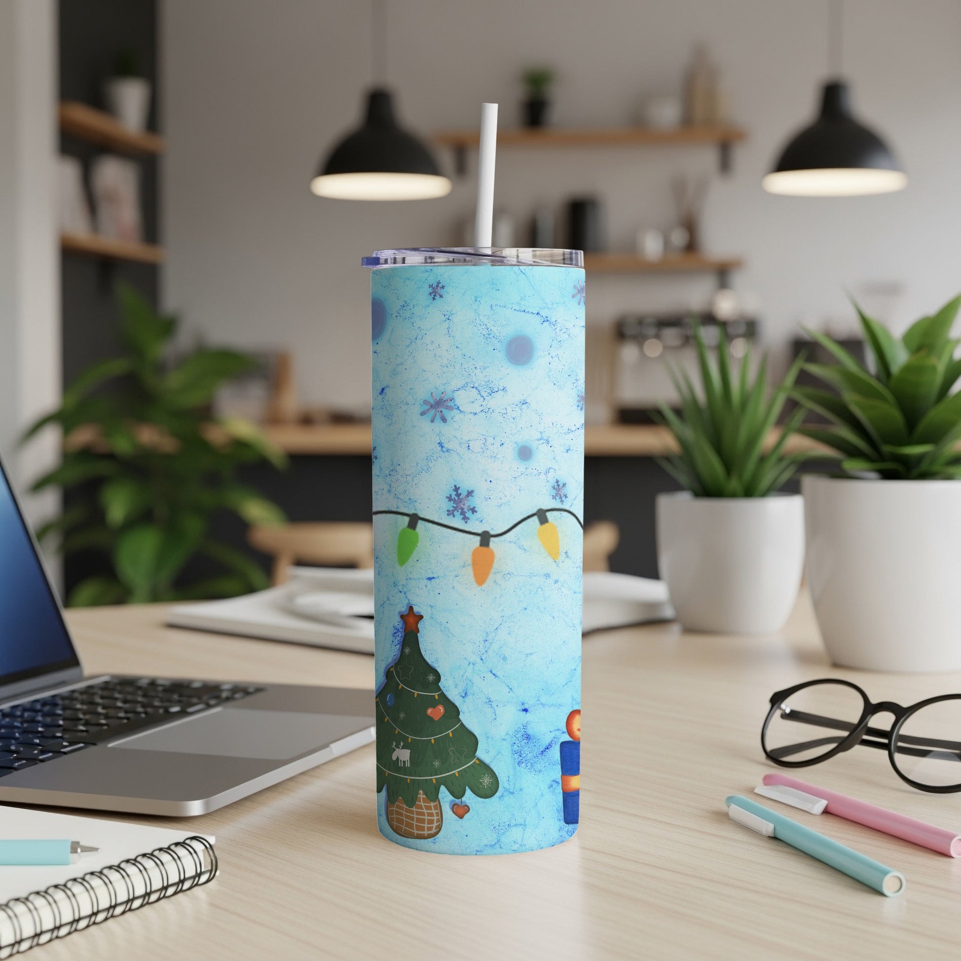Blue tumbler with Christmas tree, string lights, and snowflakes design.