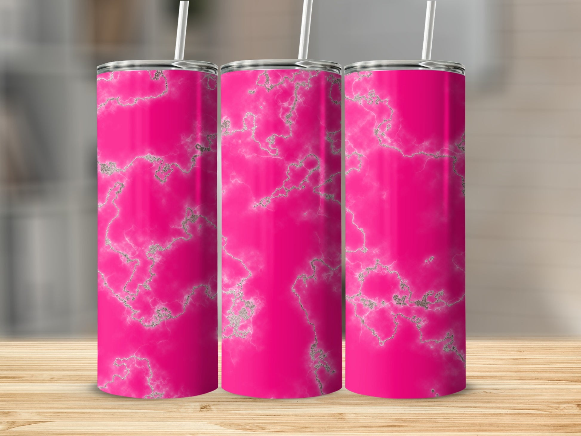 Three pink tumblers with silver marble patterns and straws.
