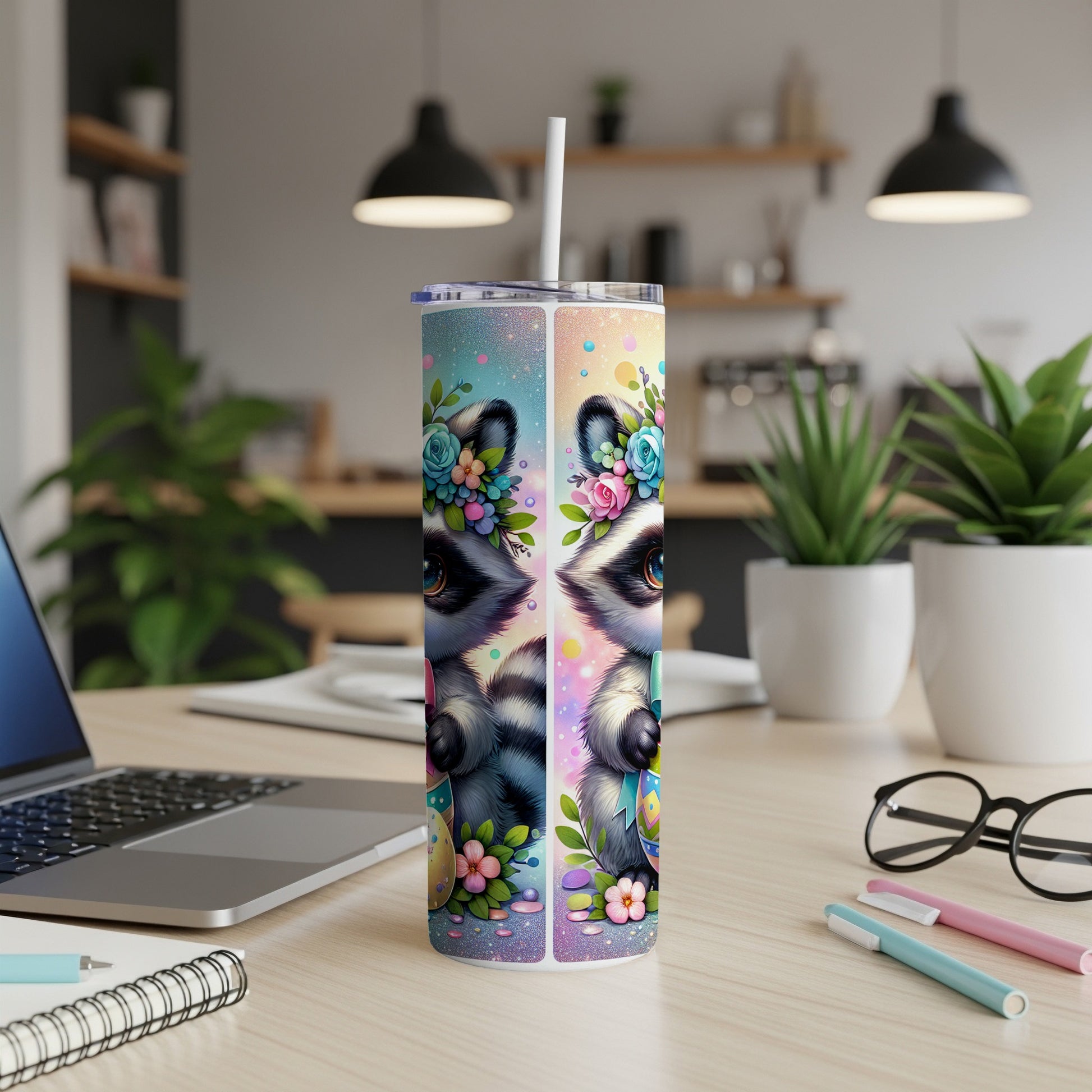 Tumbler with a raccoon face and colorful floral Easter egg decorations.