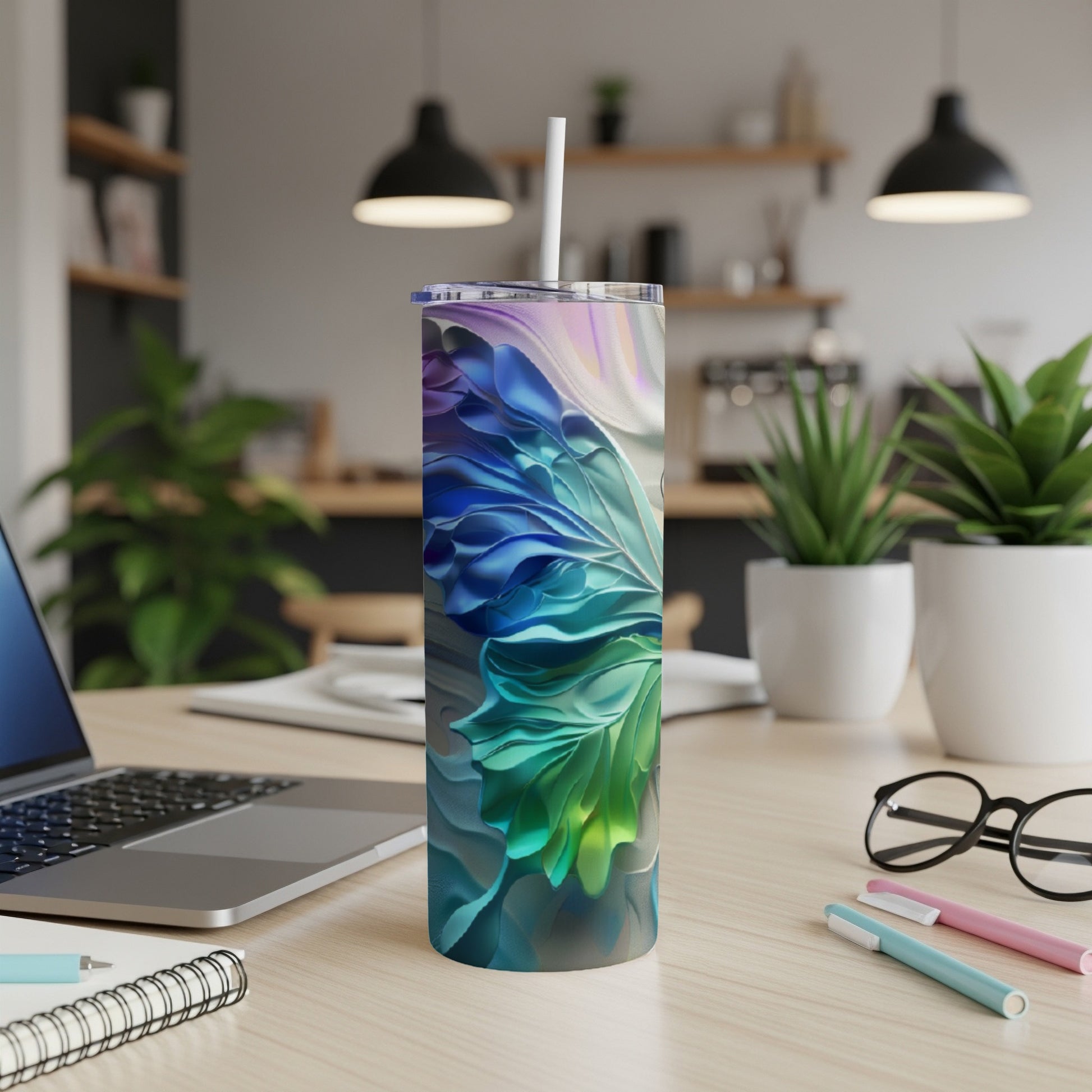 Tall tumbler with abstract blue, green, and purple floral design.