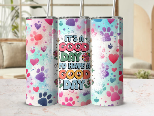 Tumbler with colorful paw prints and "It's a Good Day to Have a Good Day" text.