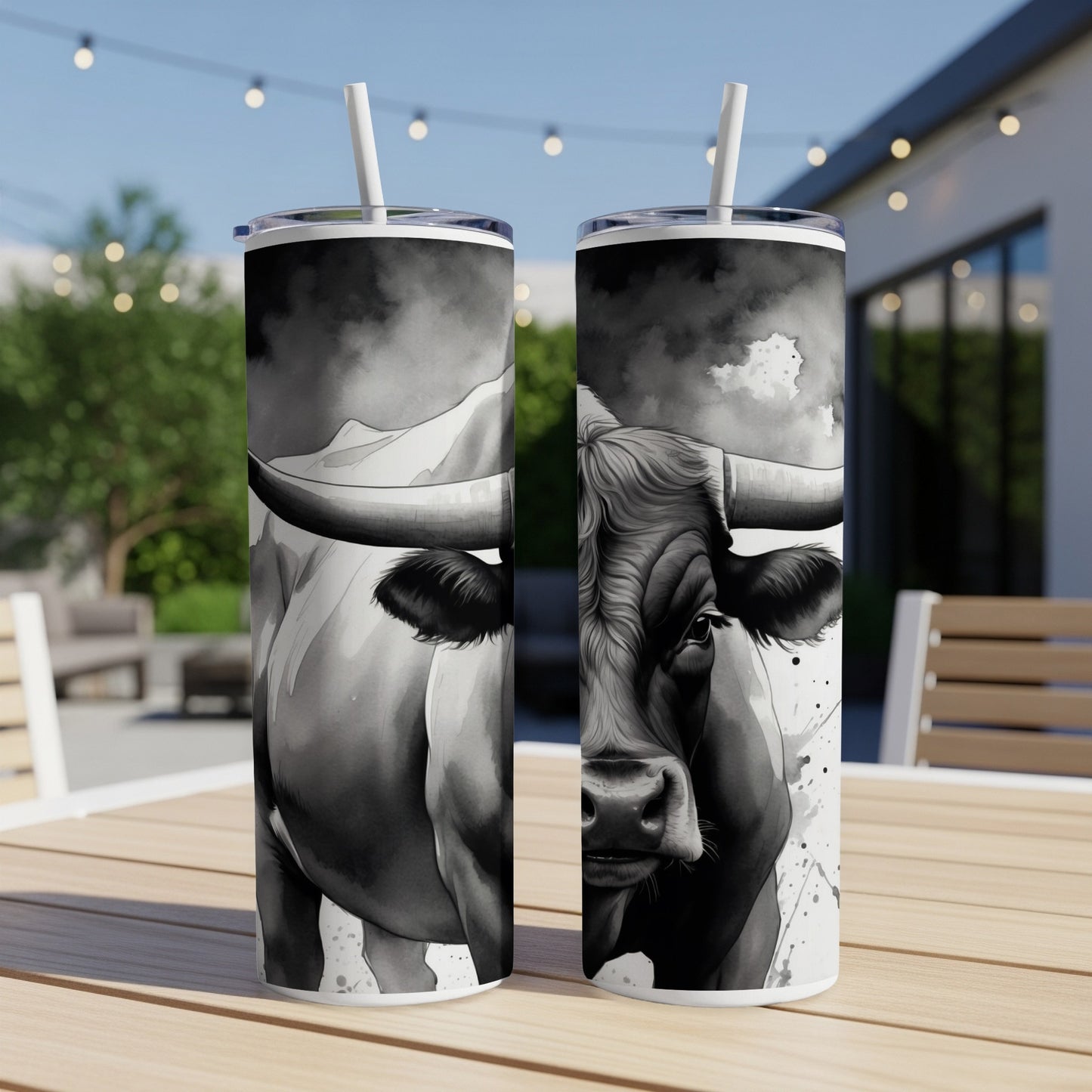 Black and white bull illustration on two tumblers with straws.