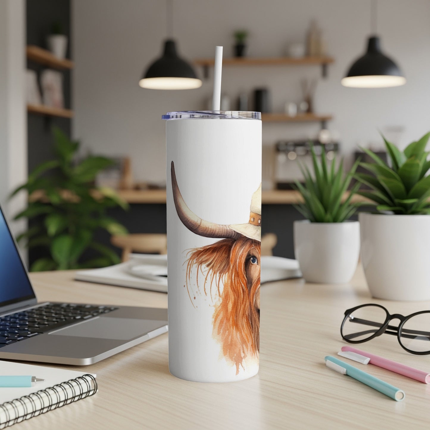 White tumbler with Highland cow wearing a cowboy hat, watercolor style.