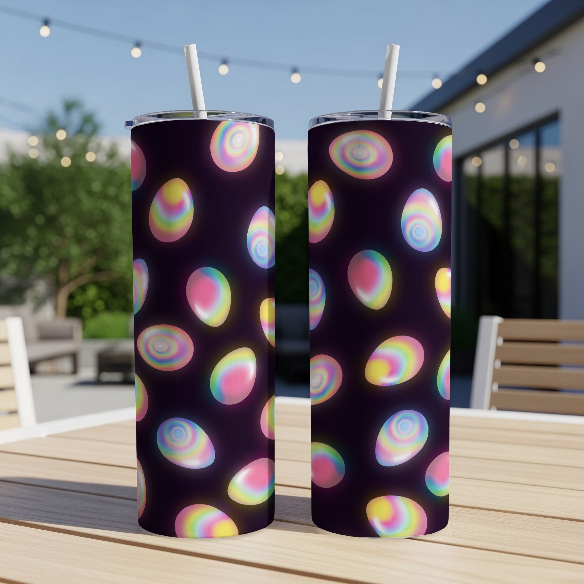 Two dark tumblers with iridescent, colorful Easter eggs.