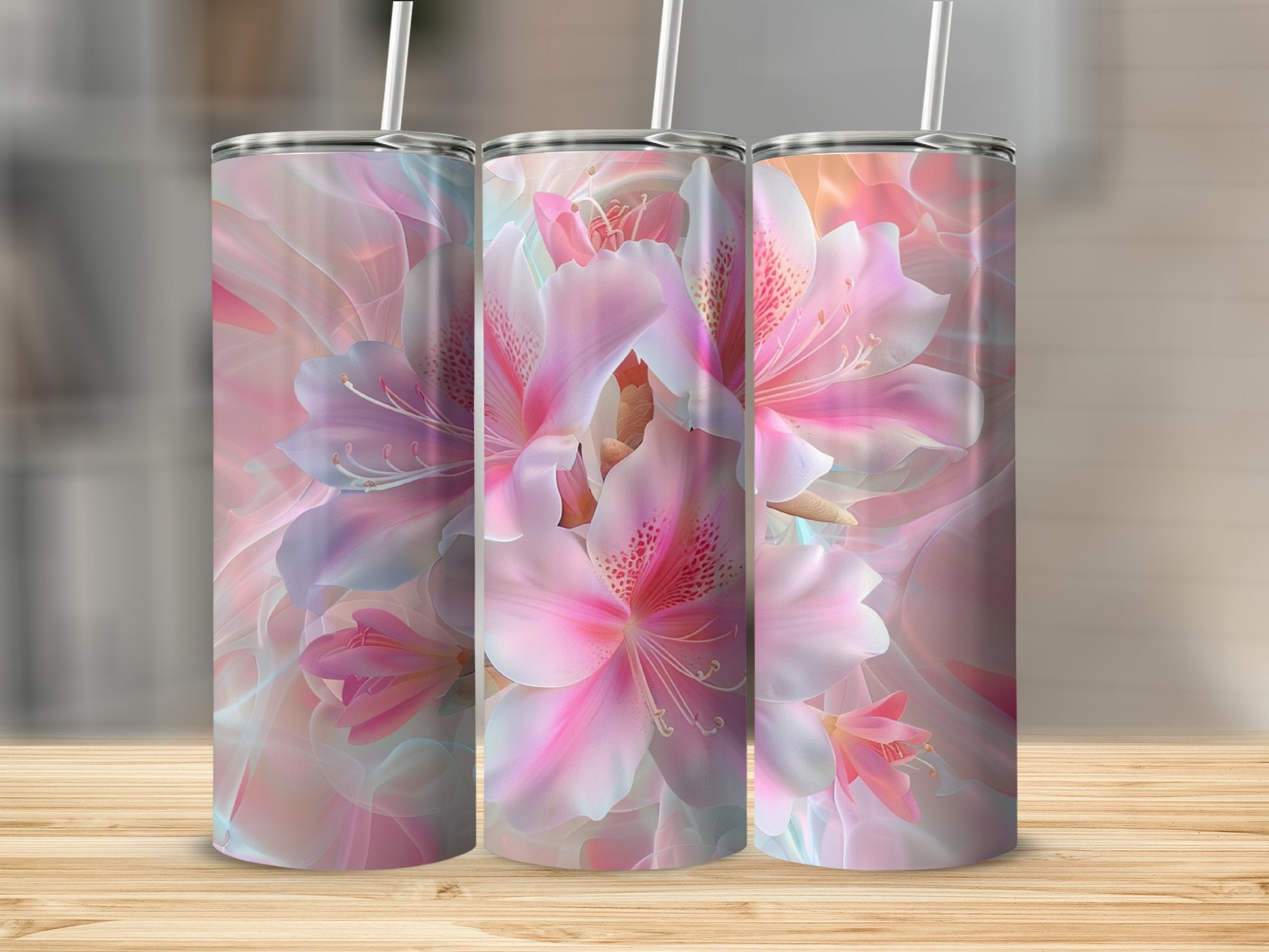Three tumblers with a pink and blue floral design on a wooden surface.