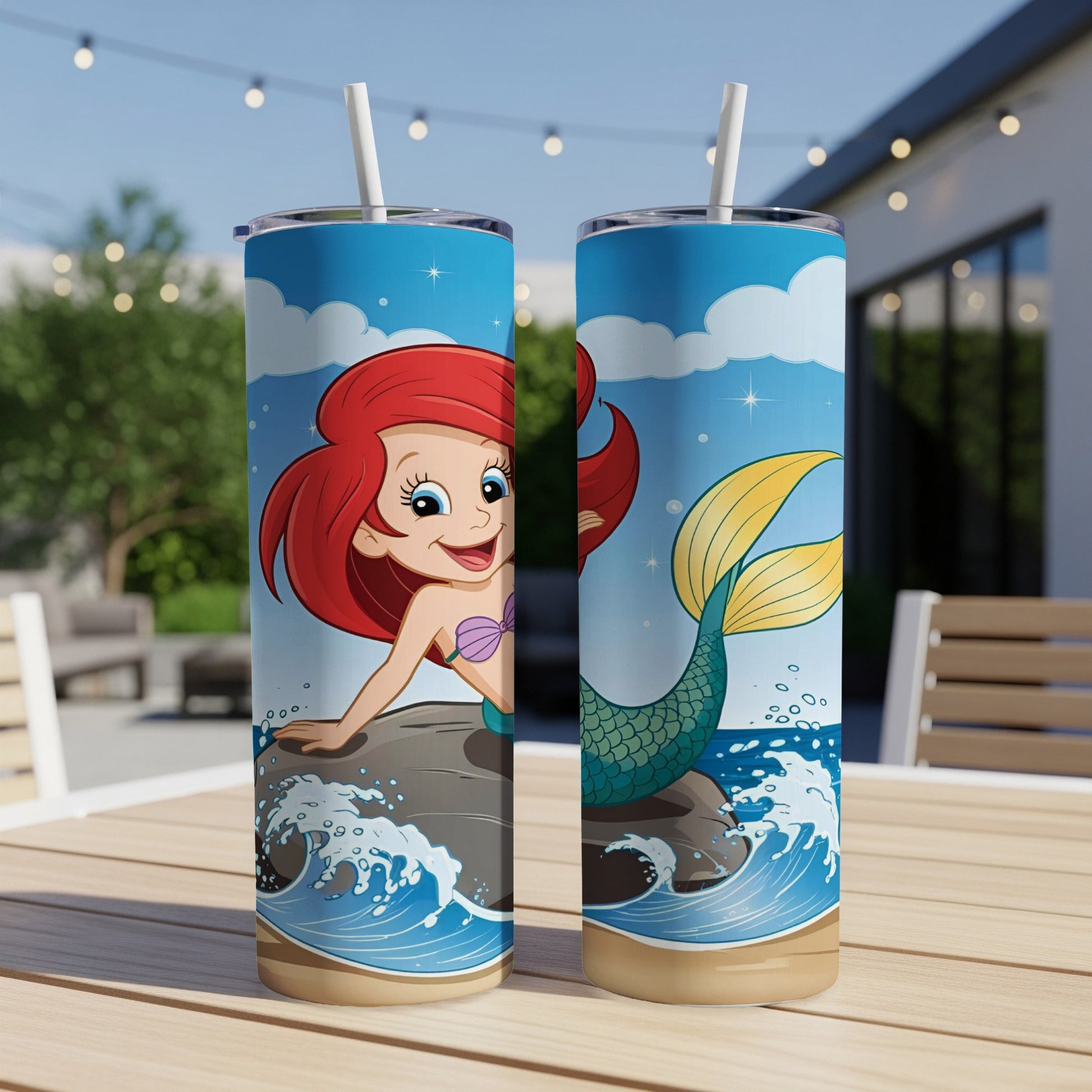 Ariel the mermaid on a rock, waves and sky, on a blue tumbler.
