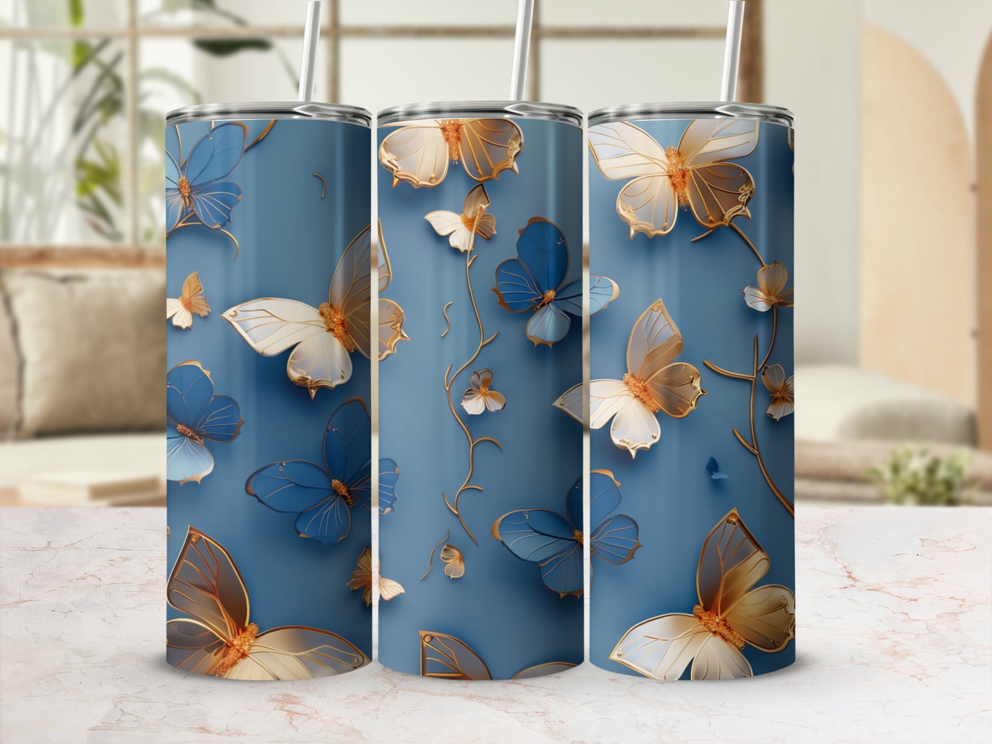 Three blue tumblers with gold and white butterflies and floral accents.