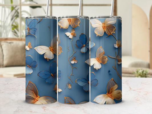 Three blue tumblers with gold and white butterflies and floral accents.