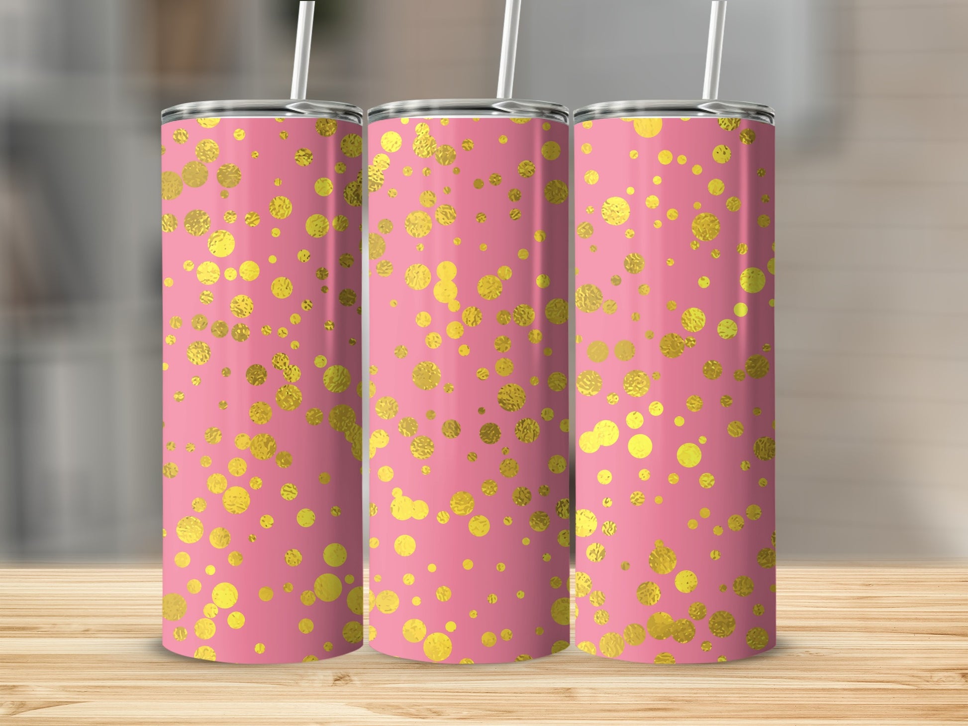 Three pink tumblers with gold foil polka dots and white straws.