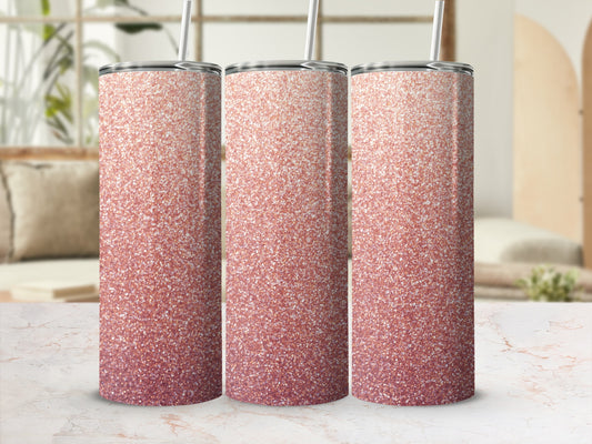 Three rose gold glitter tumblers with straws on a marble surface.