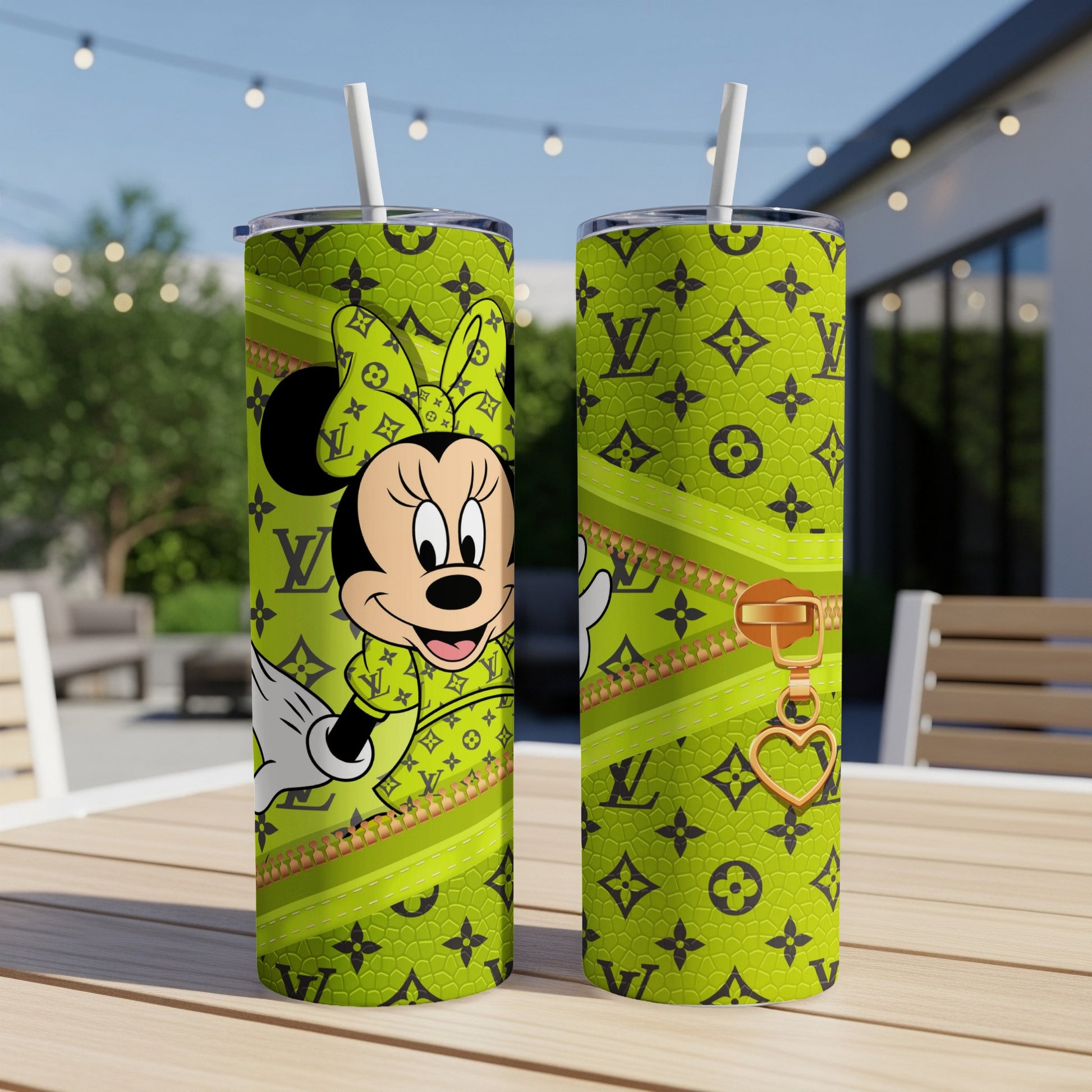 Minnie Mouse in green monogram pattern on a tumbler with gold zipper detail.