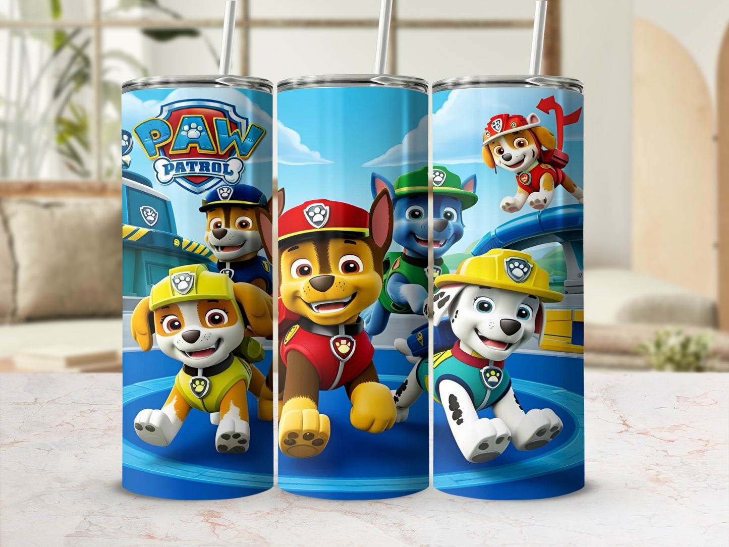 Paw Patrol pups Chase, Marshall, and Skye on a blue tumbler with a straw.