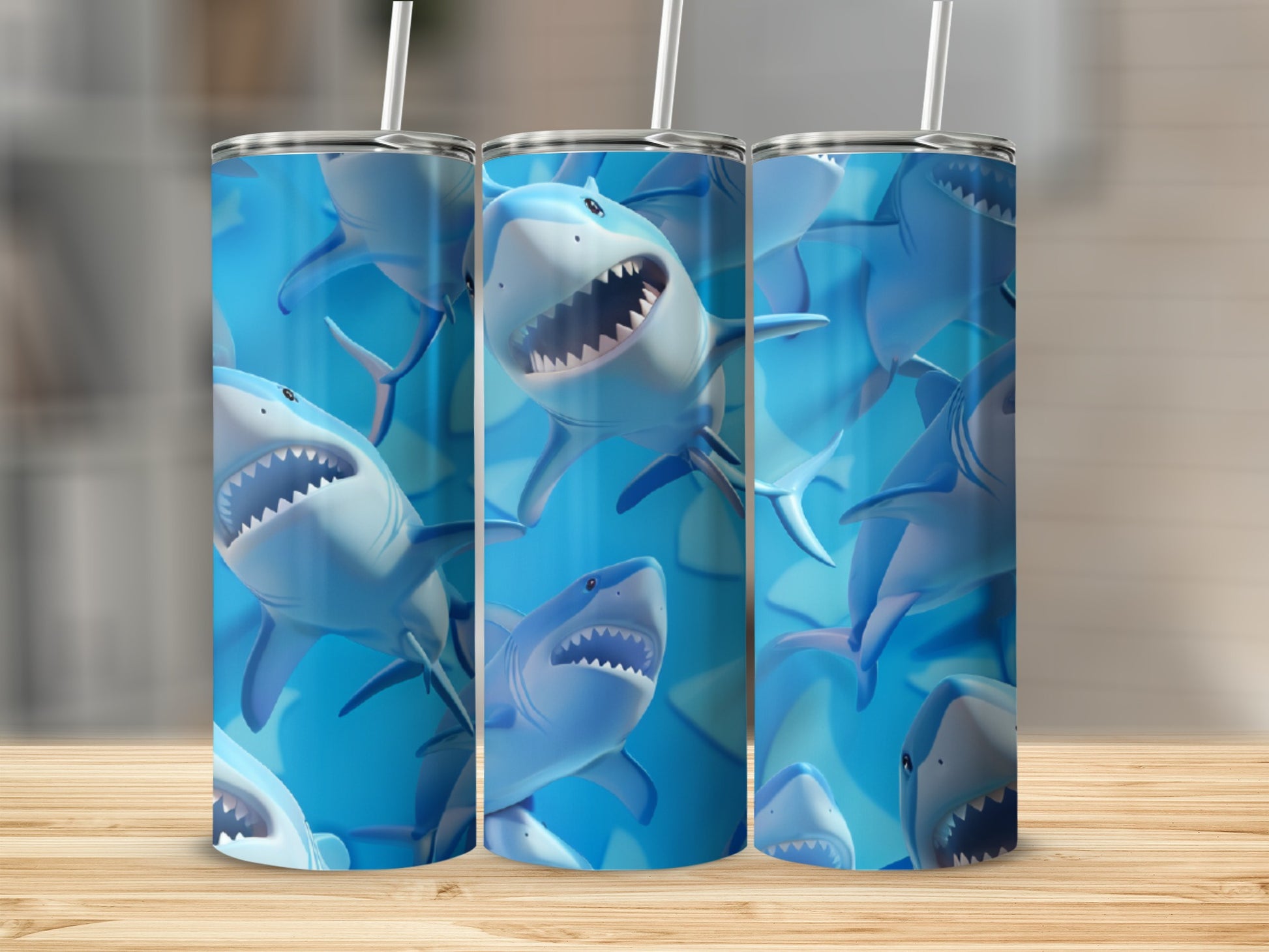 Three tall tumblers with cartoon sharks and blue water backgrounds.