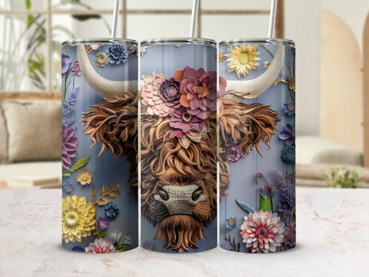 Floral Highland cow tumbler with rustic blue wood background and textured base.