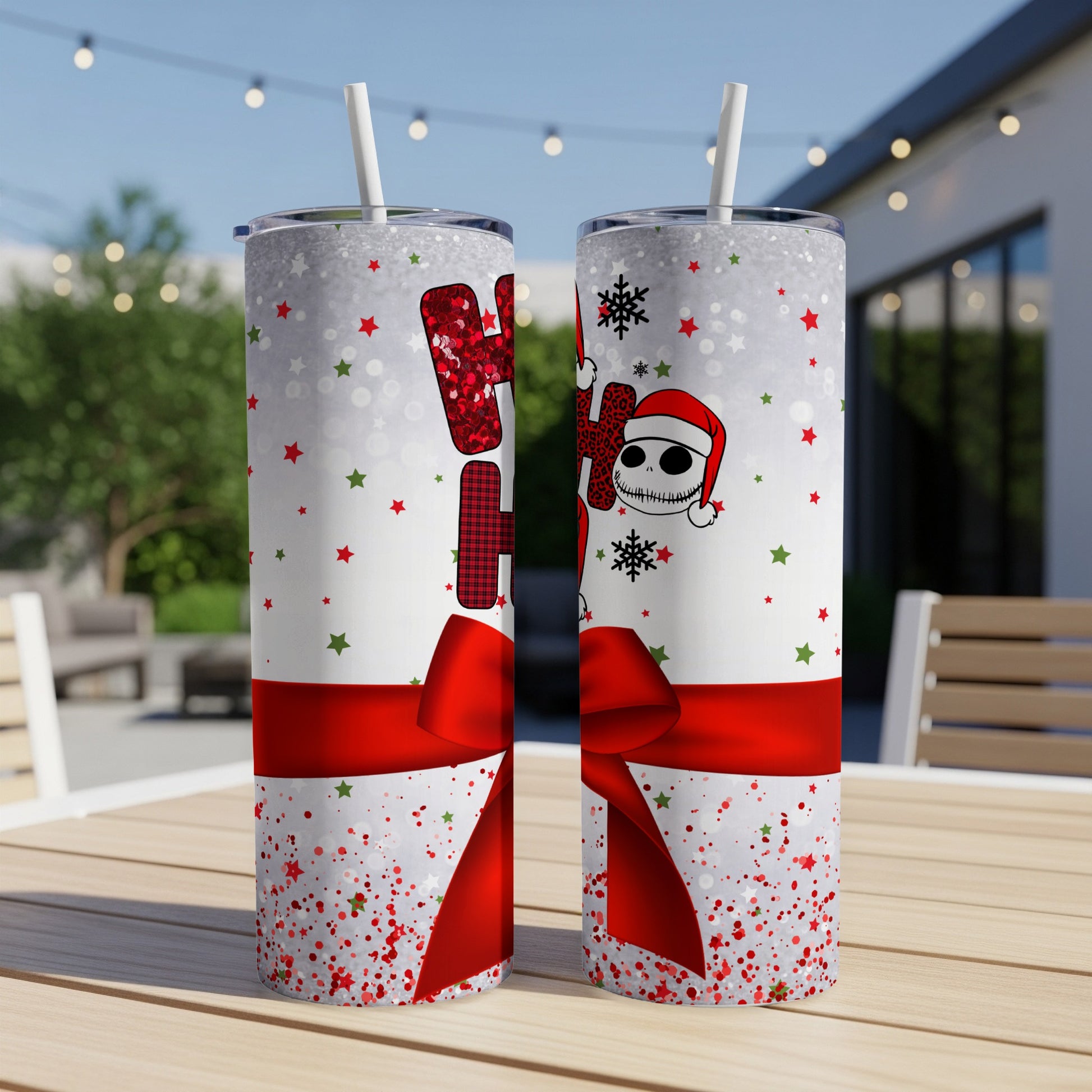 Two tall tumblers with a holiday Nightmare Before Christmas design and red bows.