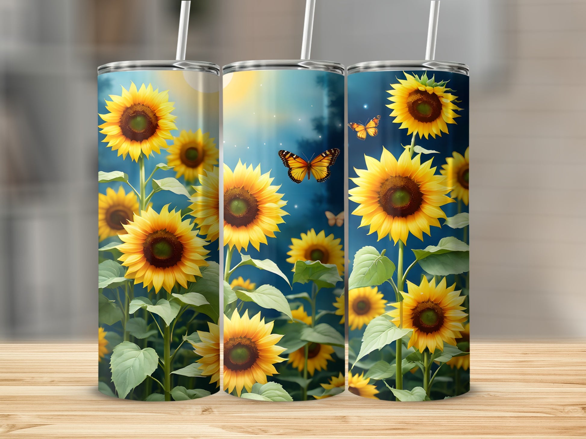 Sunflower pattern on three insulated tumblers with straws.