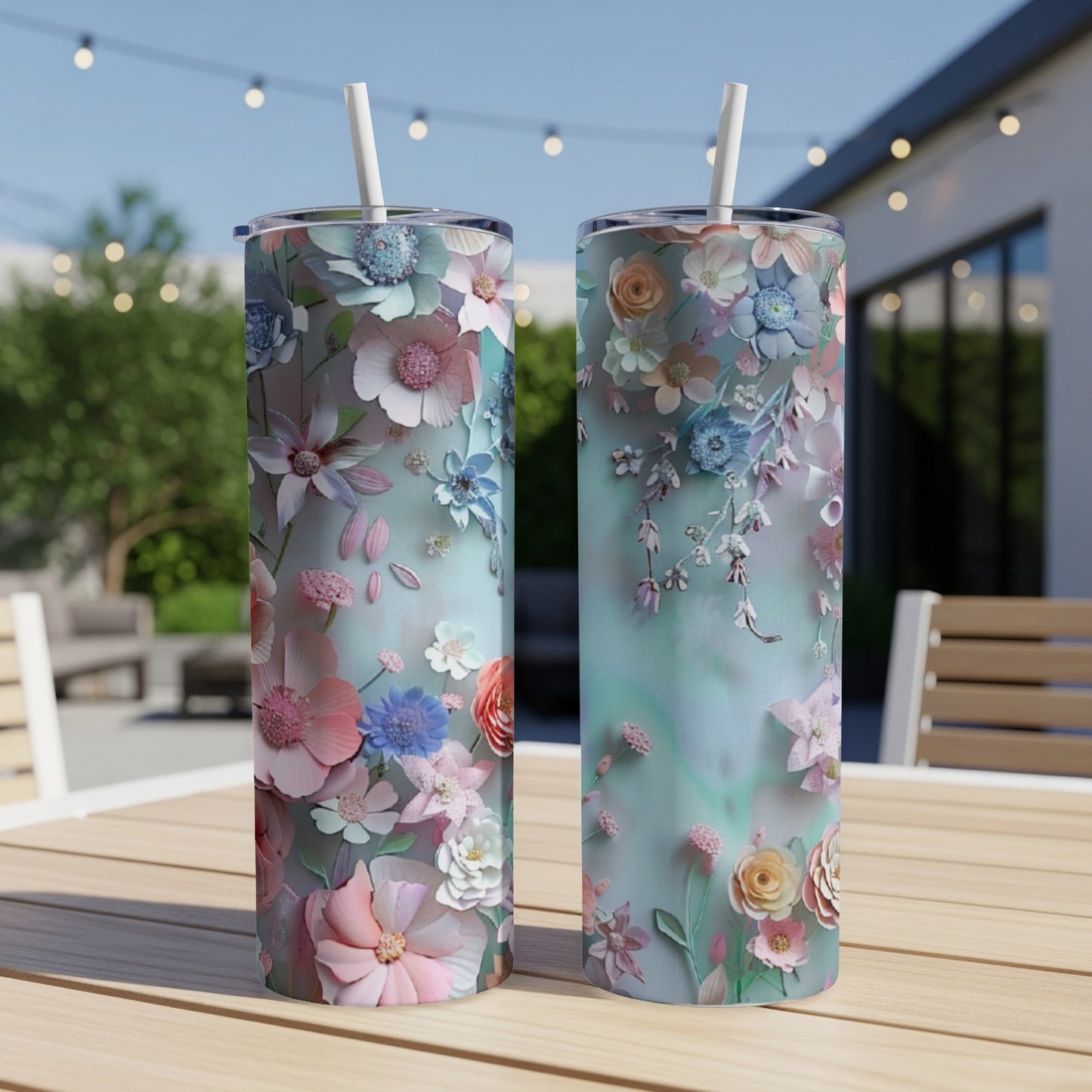 Two tumblers with a watercolor floral design sit on a wooden table.