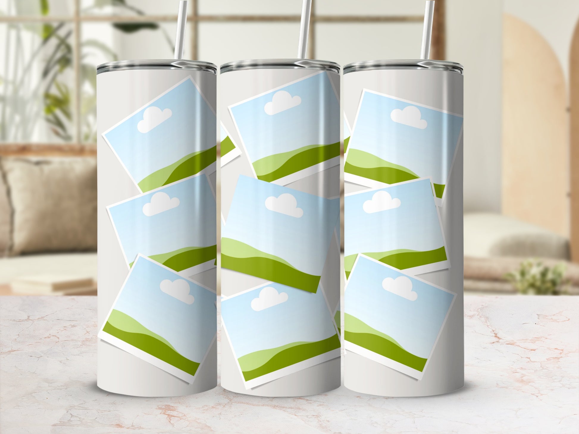 Three tumblers with a collage of landscape photos and straws.