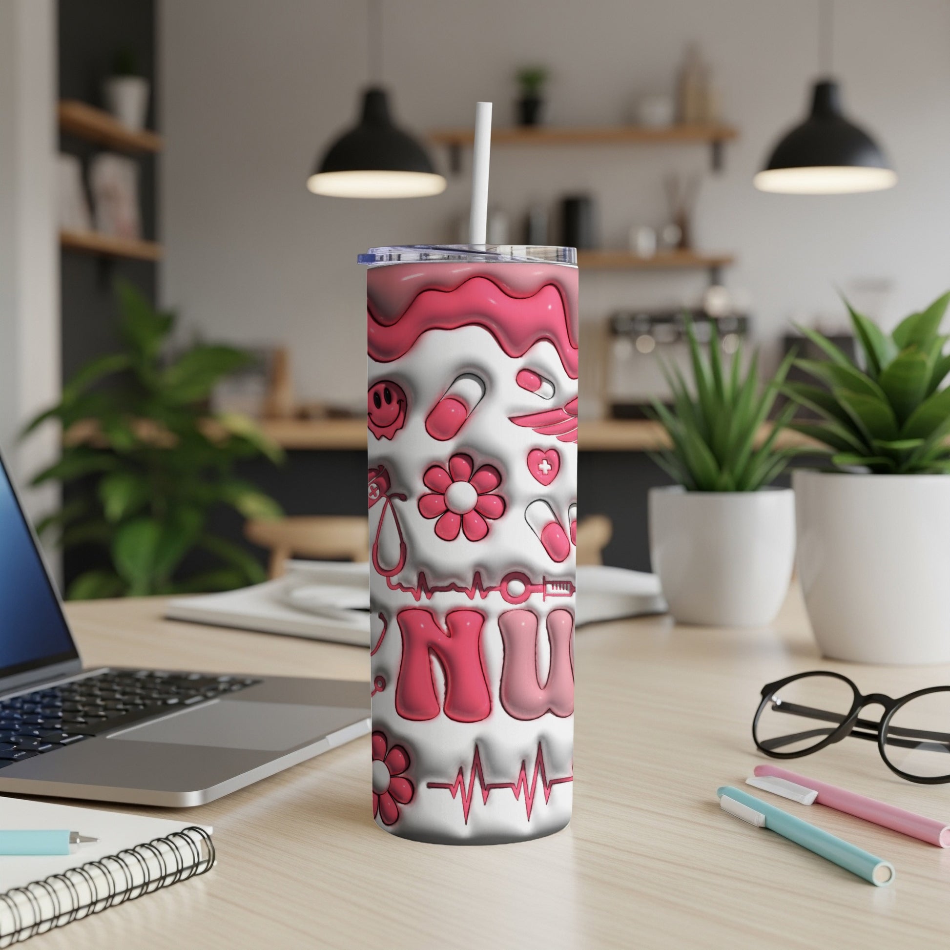 Pink and white tumbler with "RN" and medical icons on a desk.