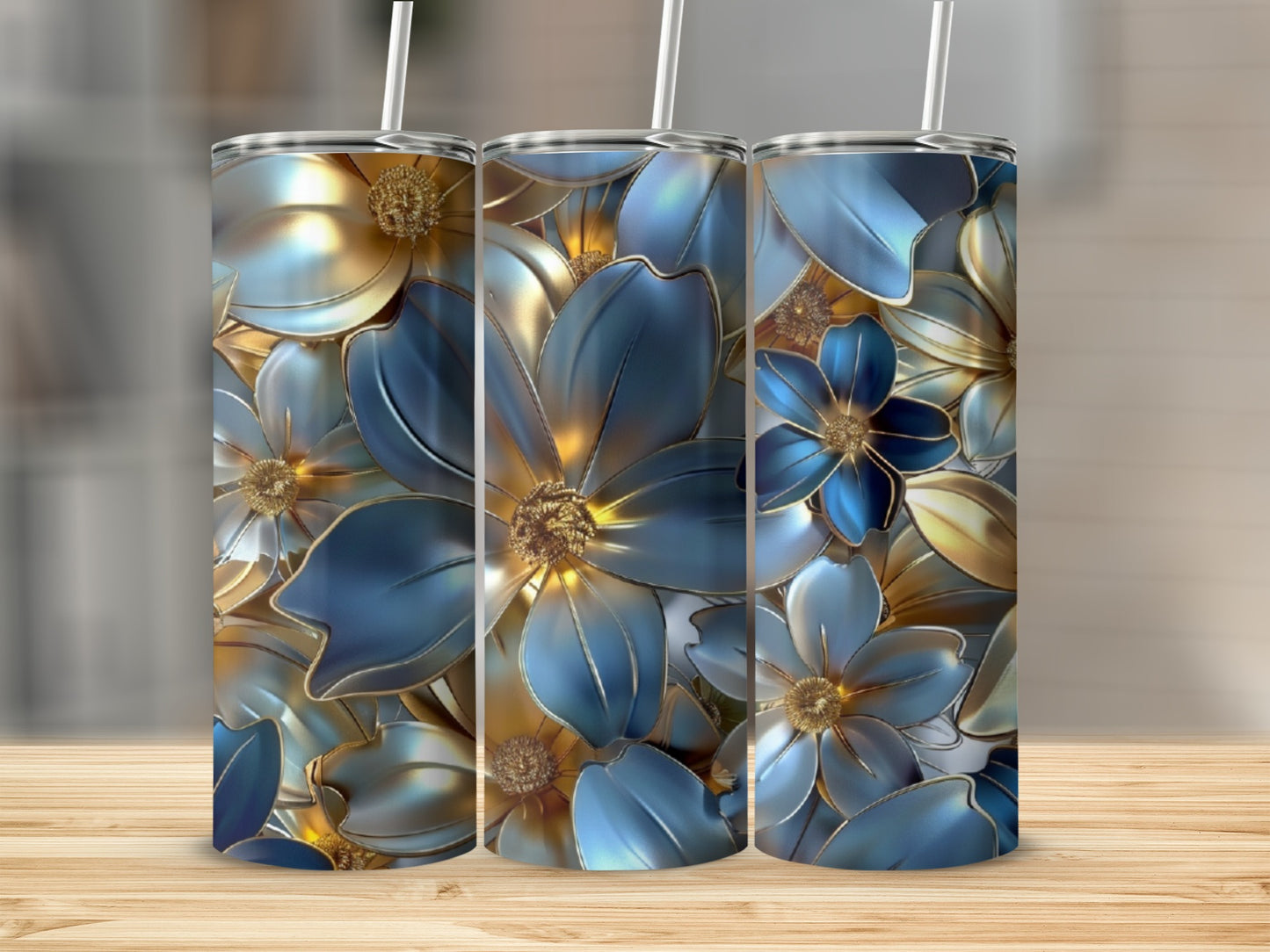 Three tumblers with a blue and gold floral design sit on a wooden surface.