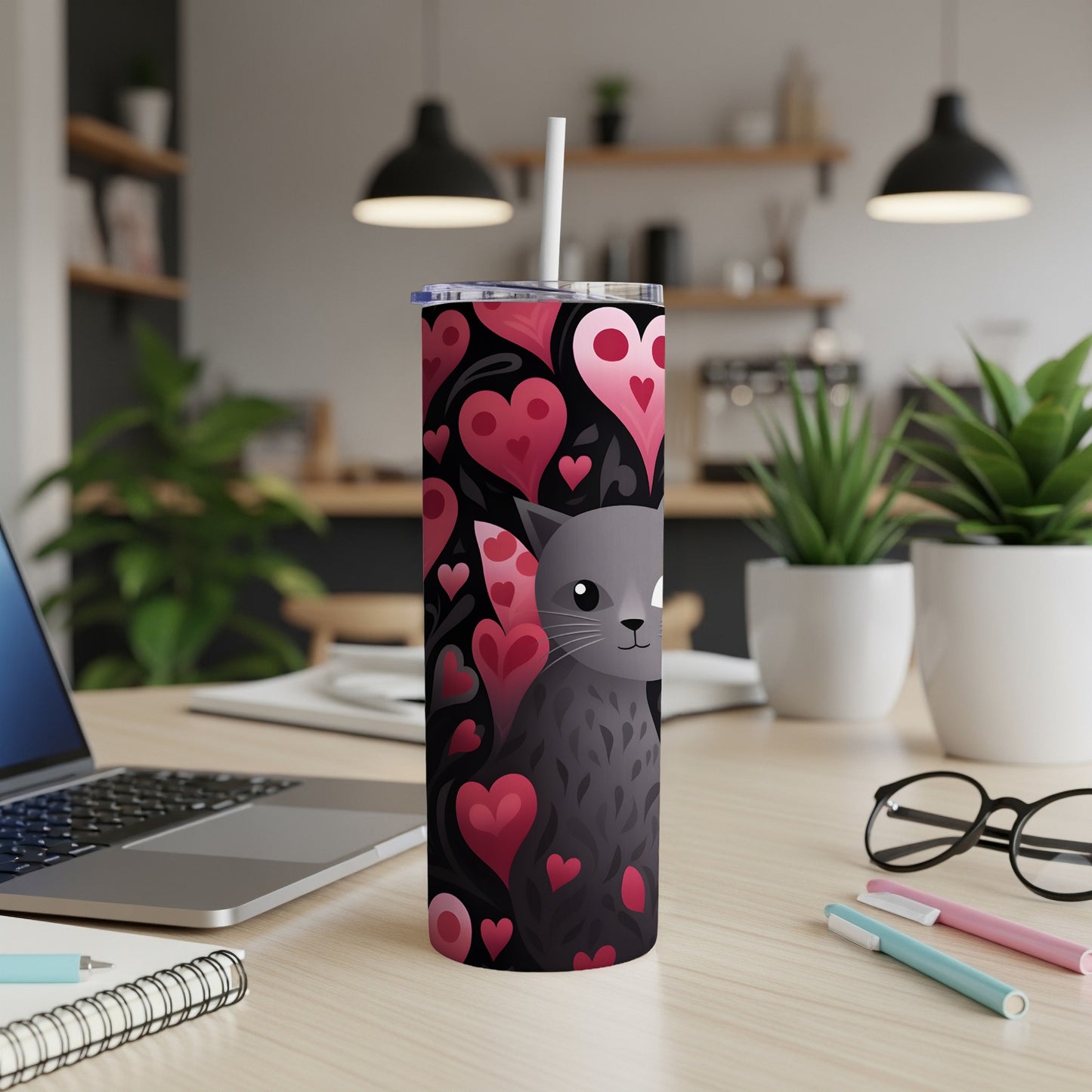 Black cat with hearts pattern on a black tumbler with straw.