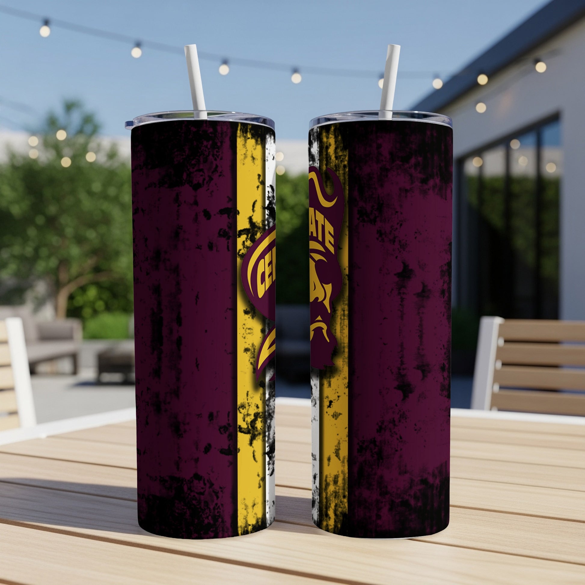 Two tumblers with maroon, yellow, and white distressed stripes and a logo on a table.