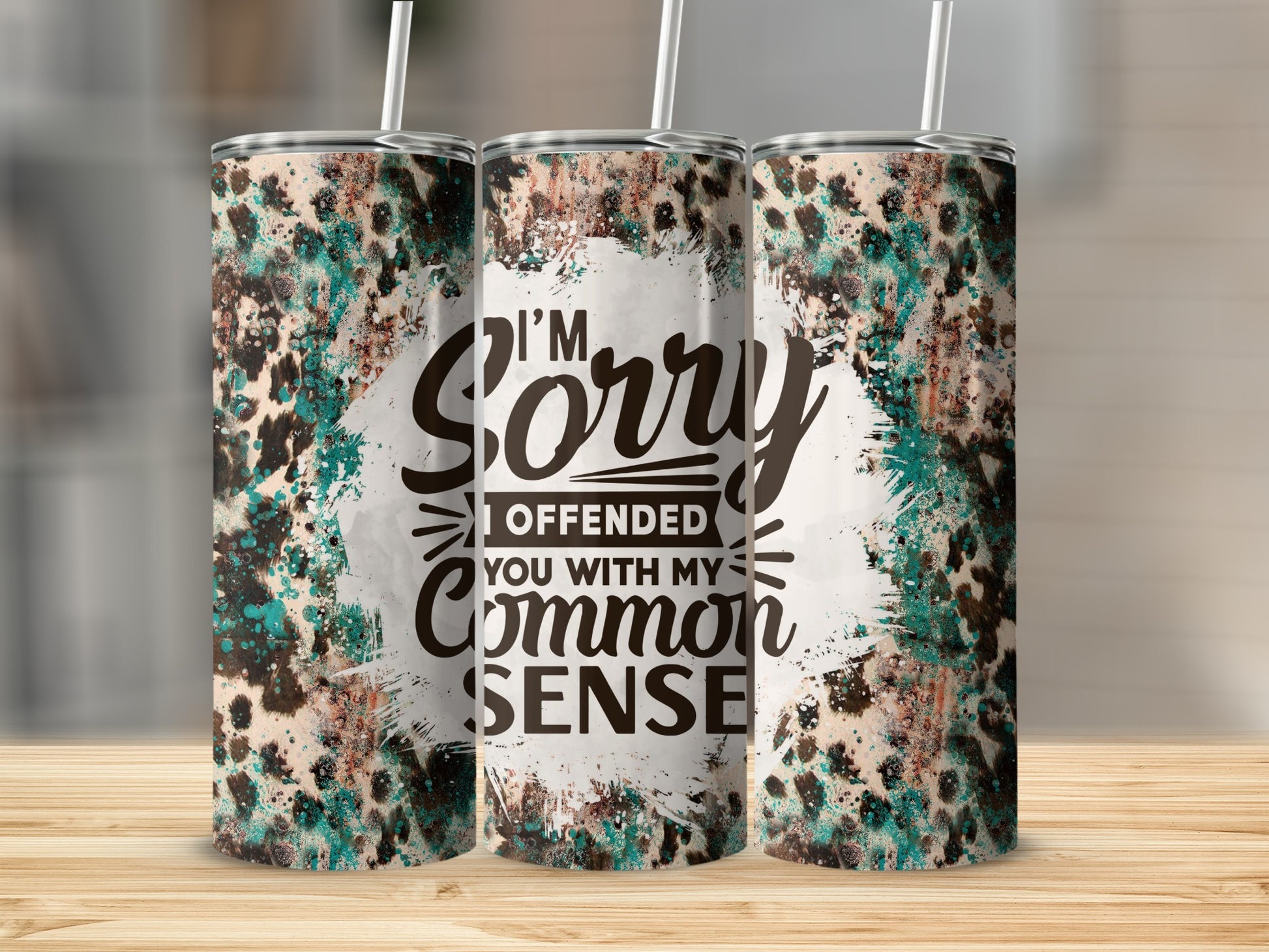 Tumbler with "I'm Sorry I Offended Your Common Sense" text and abstract print.