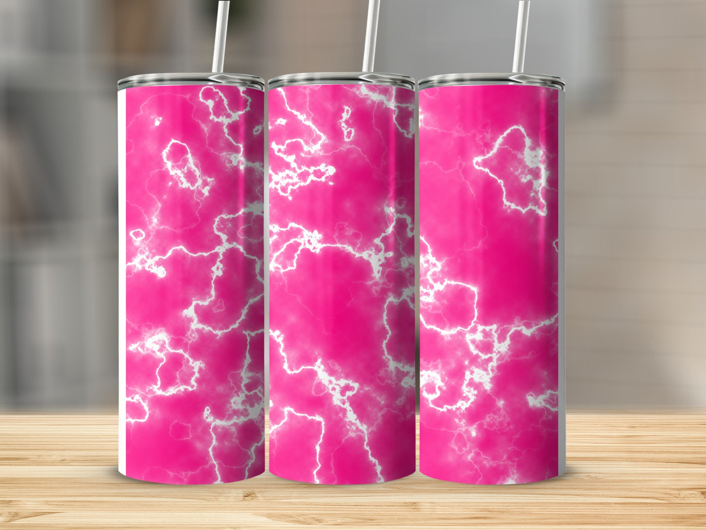 Three pink marble tumblers with white lightning patterns on a wooden surface.