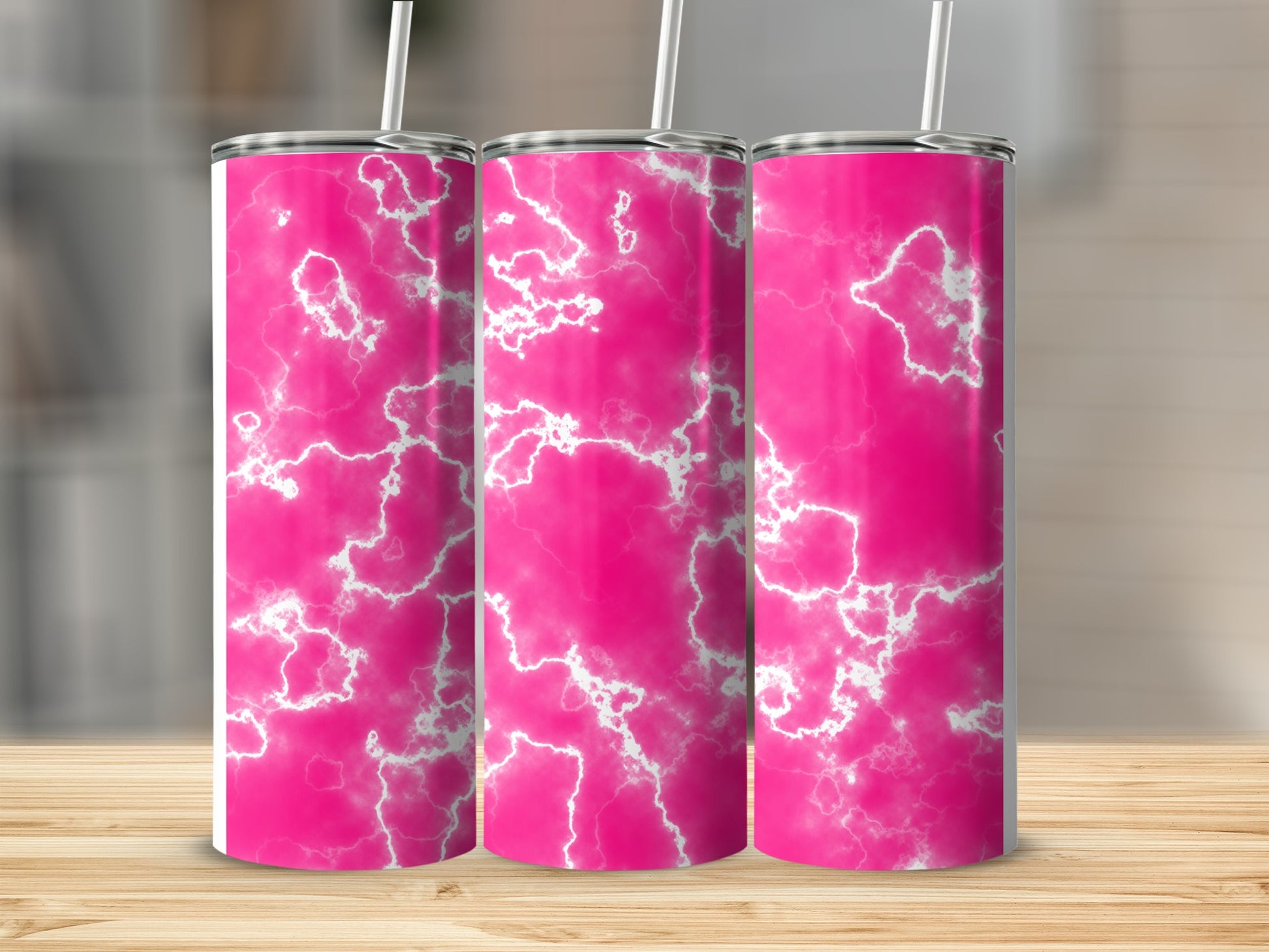 Three pink marble tumblers with white lightning patterns on a wooden surface.