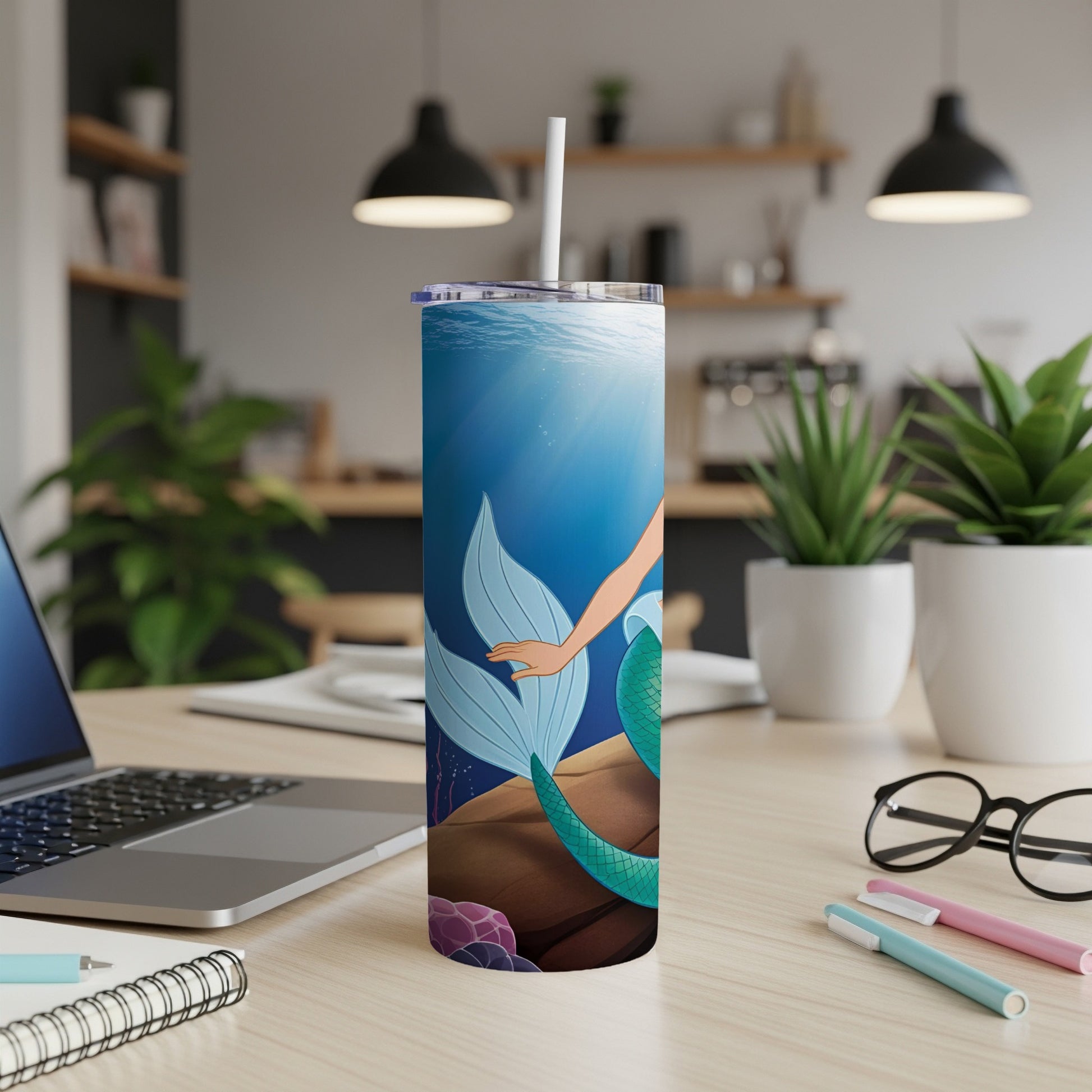 Tall blue tumbler with a mermaid tail and seashell design.