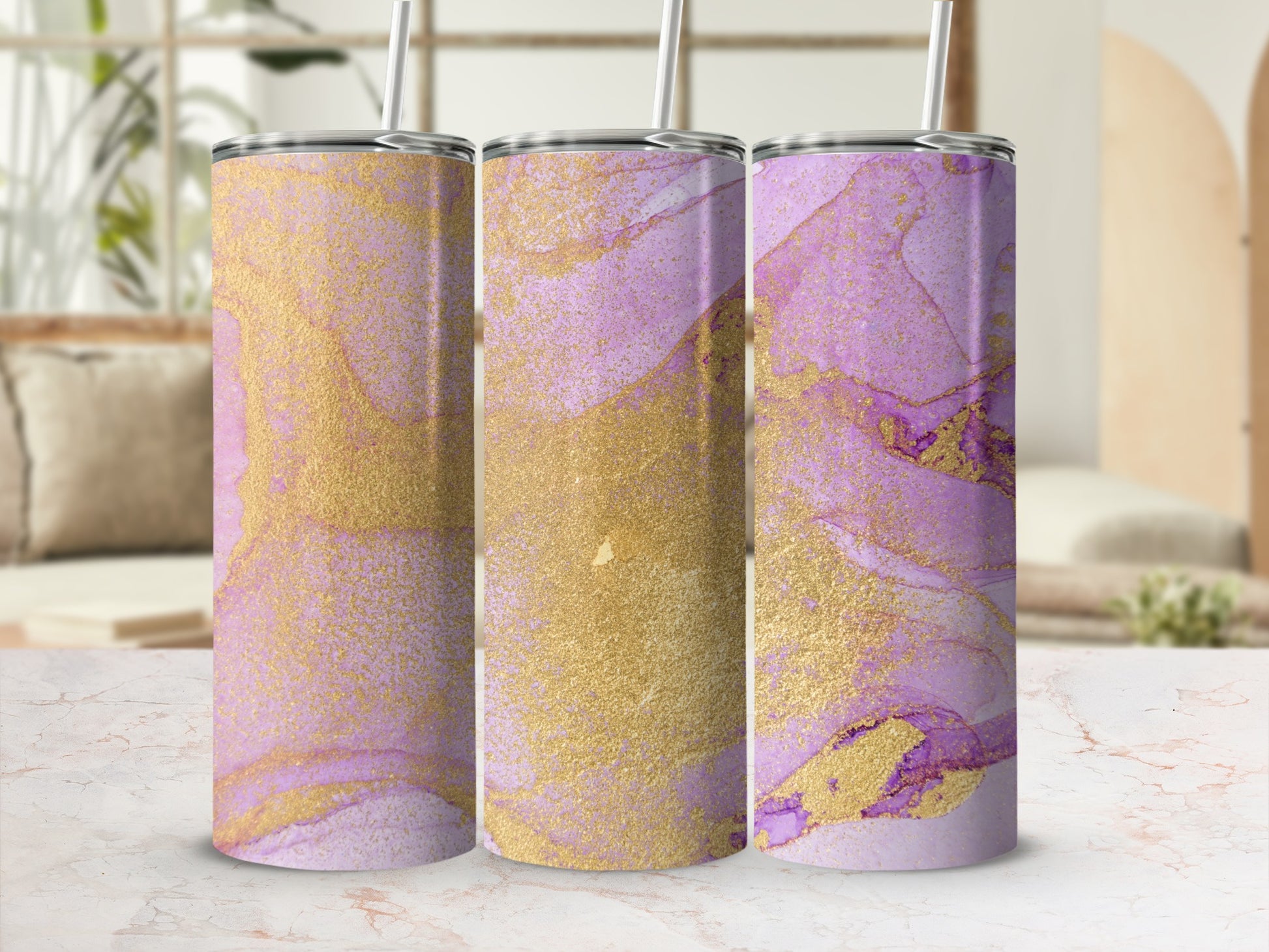Three tumblers with purple and gold abstract marbled design and straws.