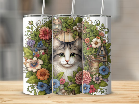 Floral wreath with cat and miniature house surrounds a tumbler.