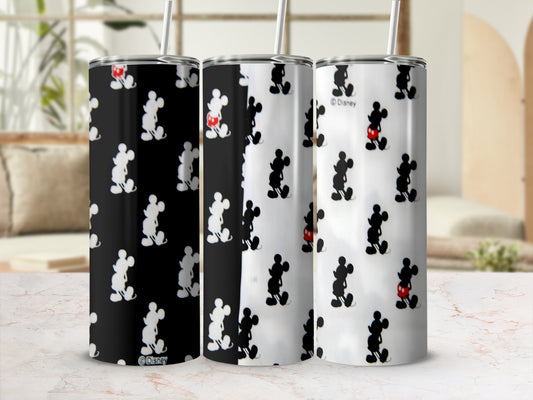 Three Disney Mickey Mouse tumblers with straws on a textured surface.