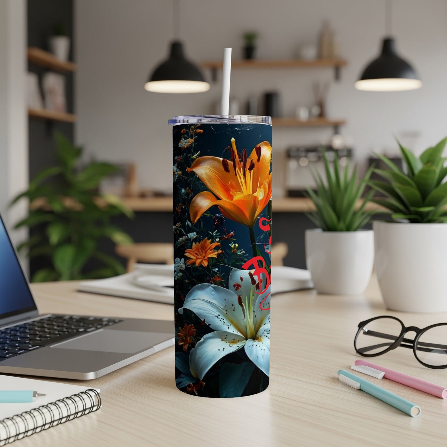 Tall tumbler with orange and white lilies against a dark background.